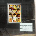 Schaufenster mit Kunstplakat: neun Masken mit weißen Brillen, rotem Mund | Shop window with art poster: nine masks wearing white glasses and red lips